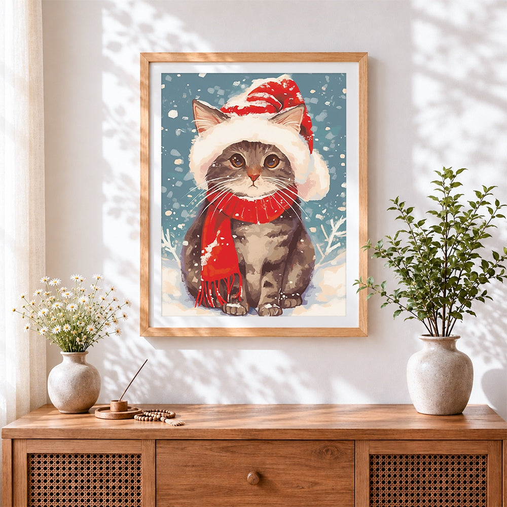 Finished snowy cat with red santa scarf cross stitch artwork displayed