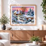 Finished snowy cottage and bridge at sunset cross stitch artwork displayed