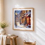 Snowy european shop street at dusk cross stitch artwork displayed on wall as home decor