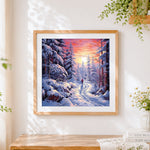 Finished snowy forest path at sunset cross stitch artwork displayed