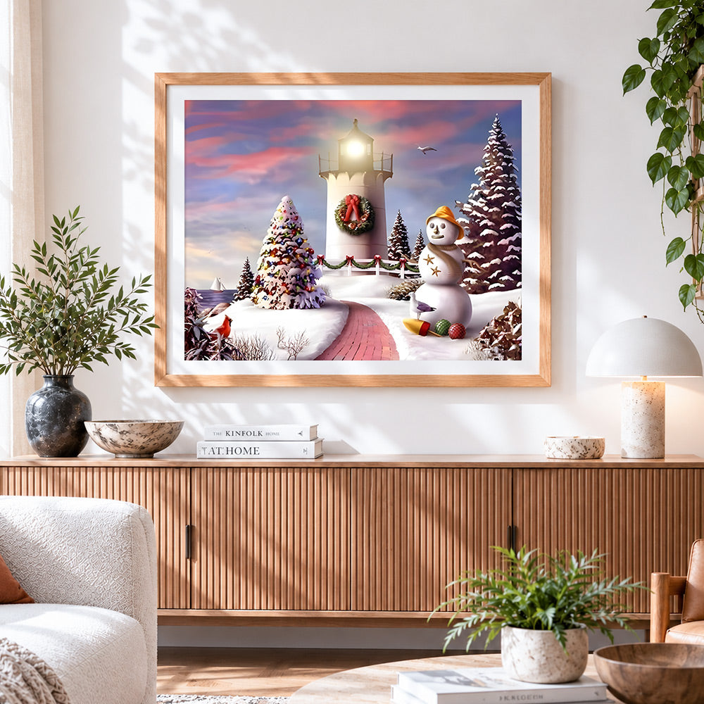 Finished snowy lighthouse and snowman coastal scene cross stitch artwork displayed