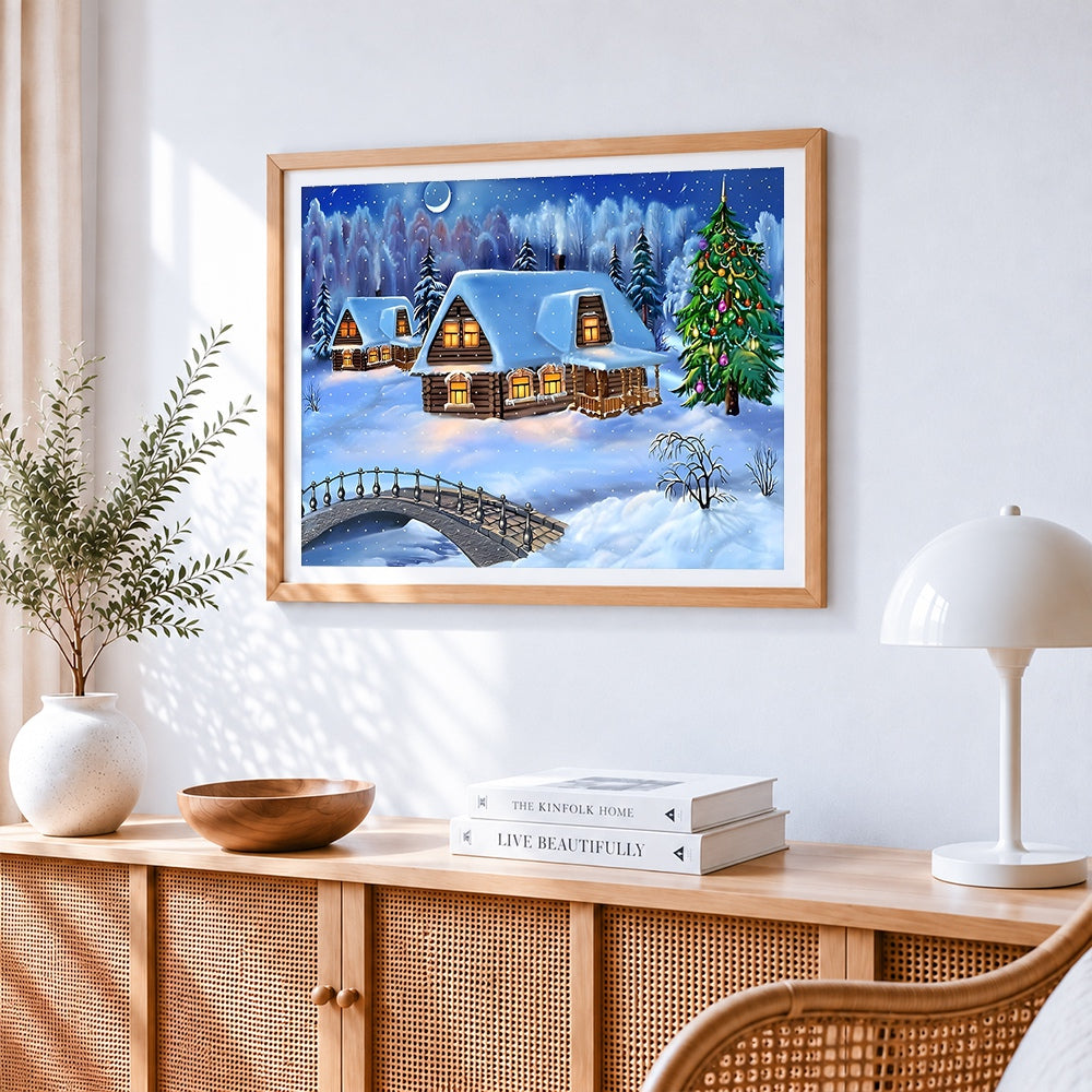 Snowy log cabins and christmas tree in winter forest cross stitch artwork displayed on wall as home decor