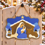 Snowy manger scene paint by numbers door hanger on a garden gate
