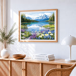 Snowy mountain lake and wildflowers cross stitch artwork displayed on wall as home decor