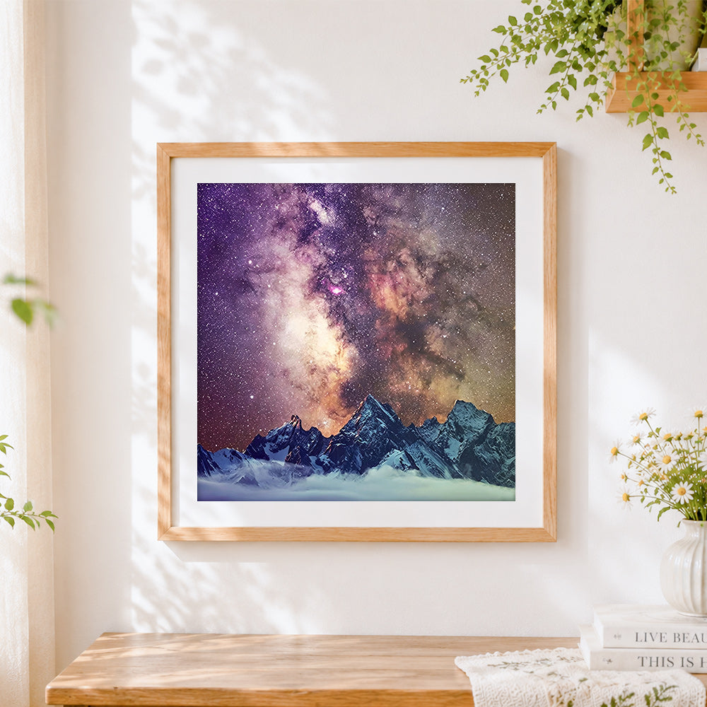 Finished snowy mountains and milky way cross stitch artwork displayed