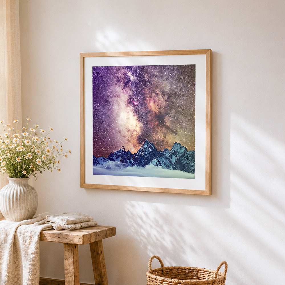 Snowy mountains and milky way cross stitch artwork displayed on wall as home decor