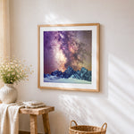 Snowy mountains and milky way cross stitch artwork displayed on wall as home decor