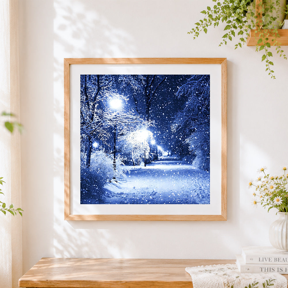 Finished snowy night forest with street lamp cross stitch artwork displayed