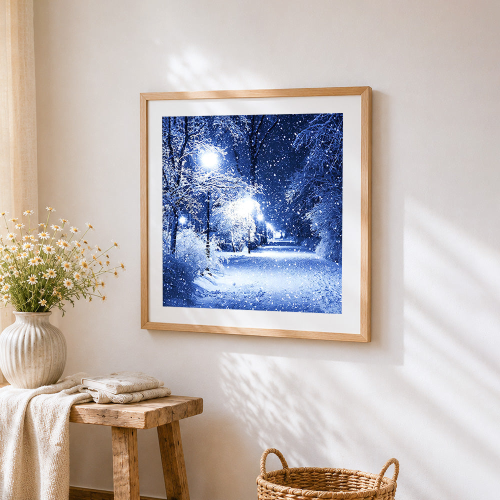 Snowy night forest with street lamp cross stitch artwork displayed on wall as home decor