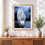 Finished snowy owl and full moon cross stitch artwork displayed