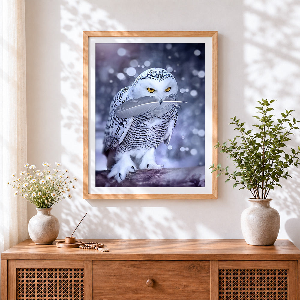 Finished snowy owl with feather cross stitch artwork displayed