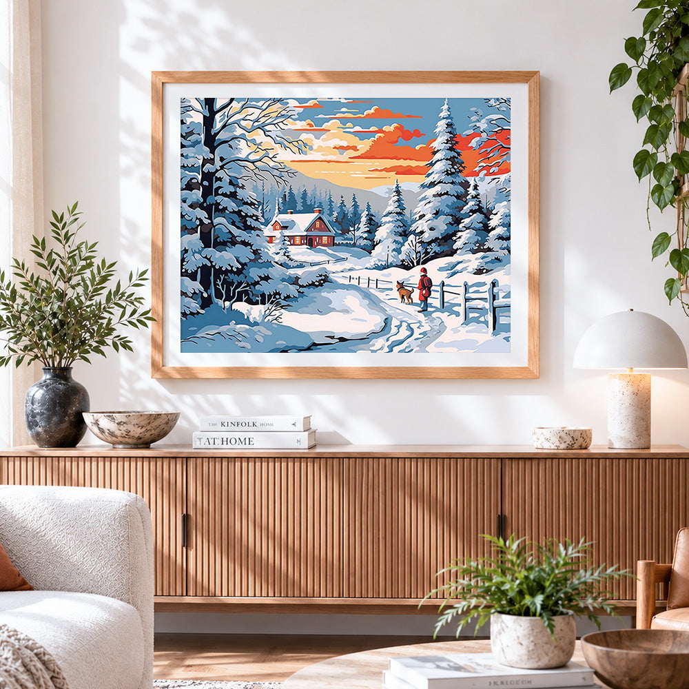Finished snowy red cabin and dog walker cross stitch artwork displayed
