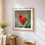 Snowy red cardinal cross stitch artwork displayed on wall as home decor