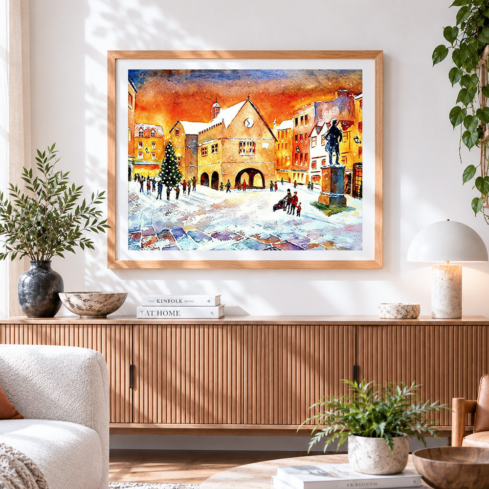 Finished snowy town square watercolour cross stitch artwork displayed
