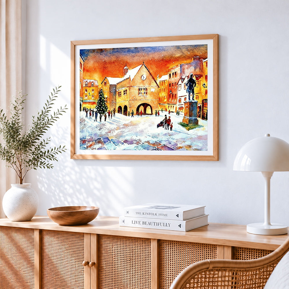 Snowy town square watercolour cross stitch artwork displayed on wall as home decor