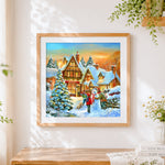 Finished snowy village and snowman by the bakery cross stitch artwork displayed