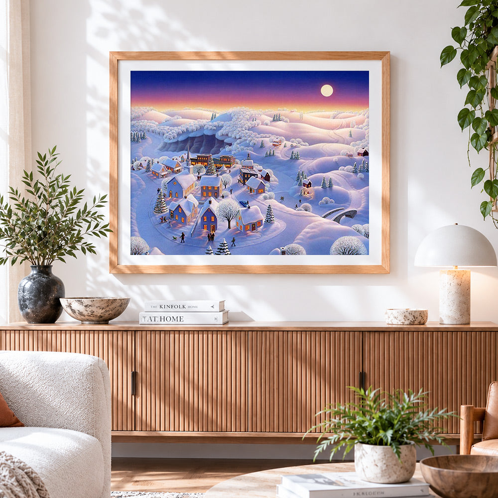 Finished snowy village in pastel twilight cross stitch artwork displayed