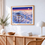 Snowy village in pastel twilight cross stitch artwork displayed on wall as home decor