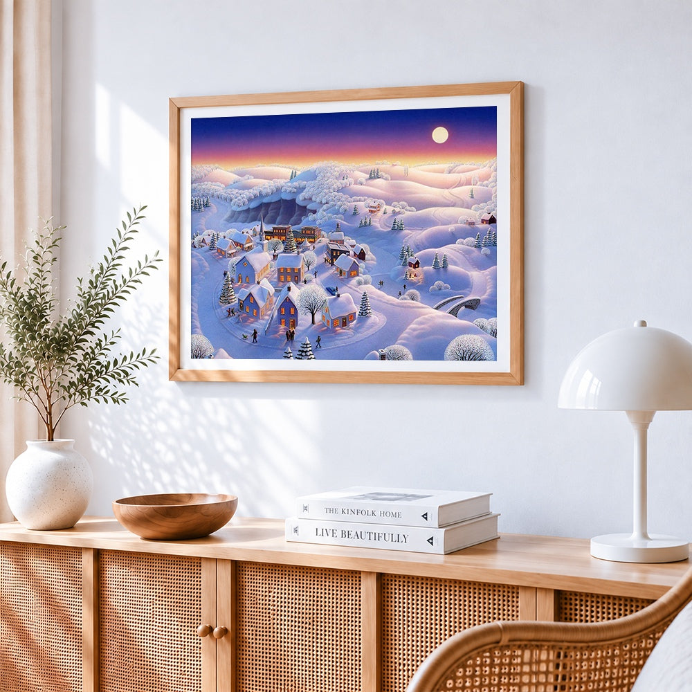 Snowy village in pastel twilight cross stitch artwork displayed on wall as home decor