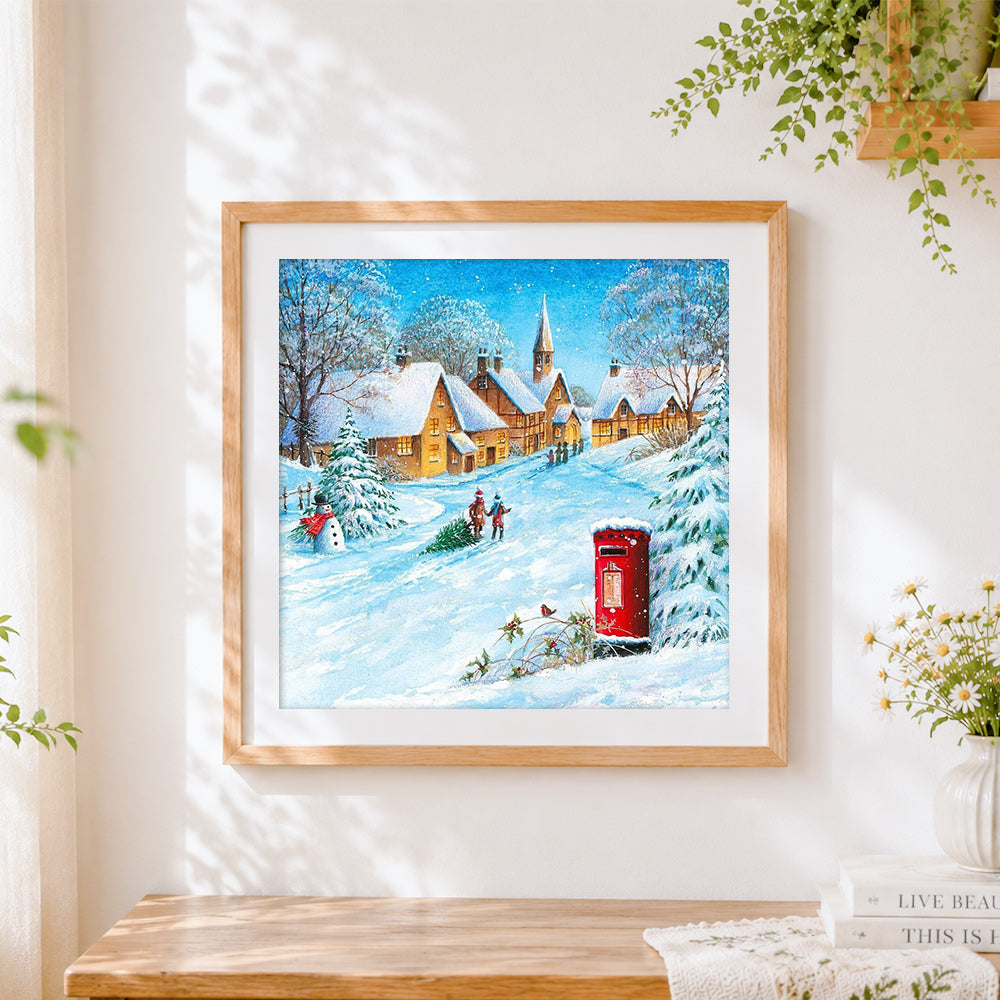 Finished snowy village with red post box cross stitch artwork displayed