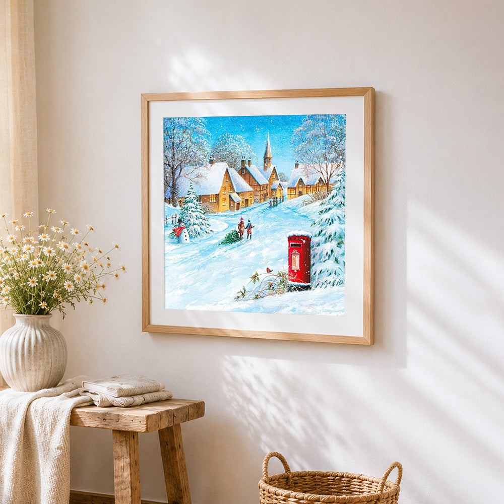 Snowy village with red post box paint by numbers artwork displayed on wall as home decor