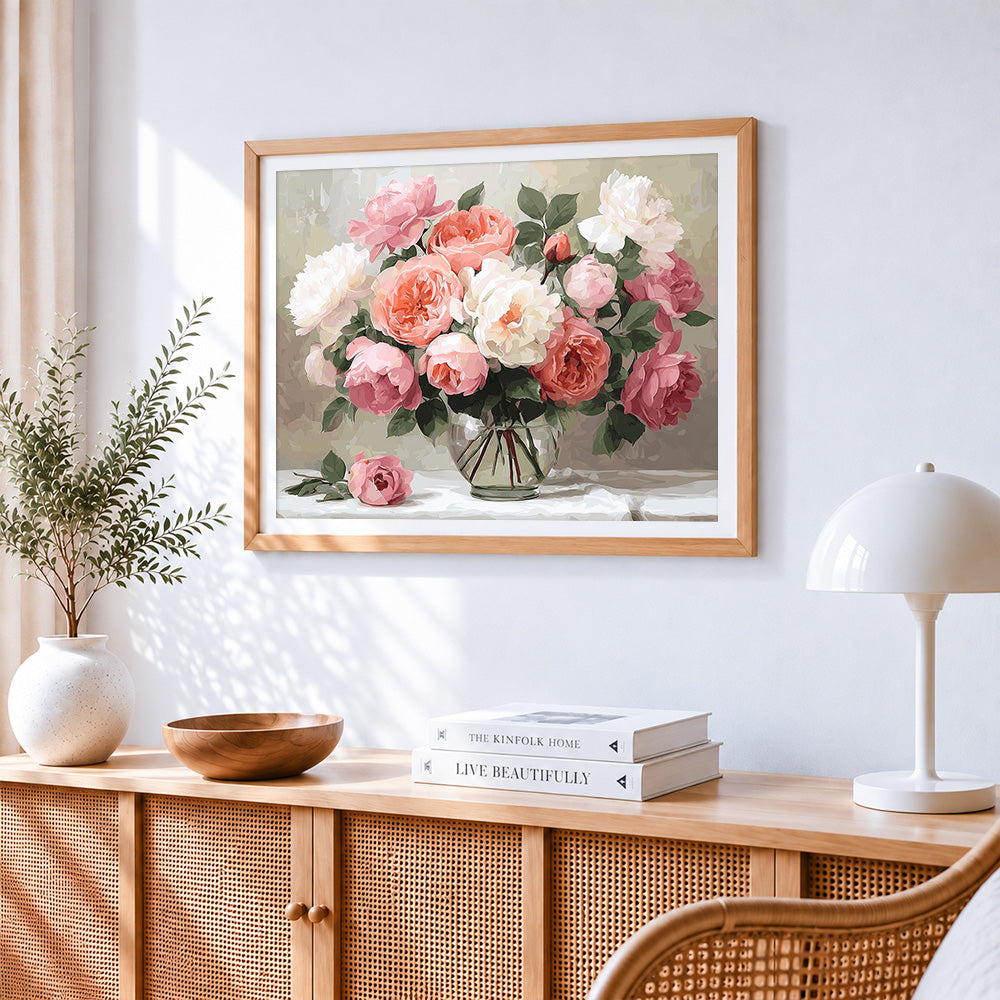Soft pastel roses in a glass vase cross stitch artwork displayed on wall as home decor