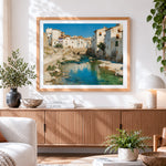 Finished spanish white town and river cross stitch artwork displayed