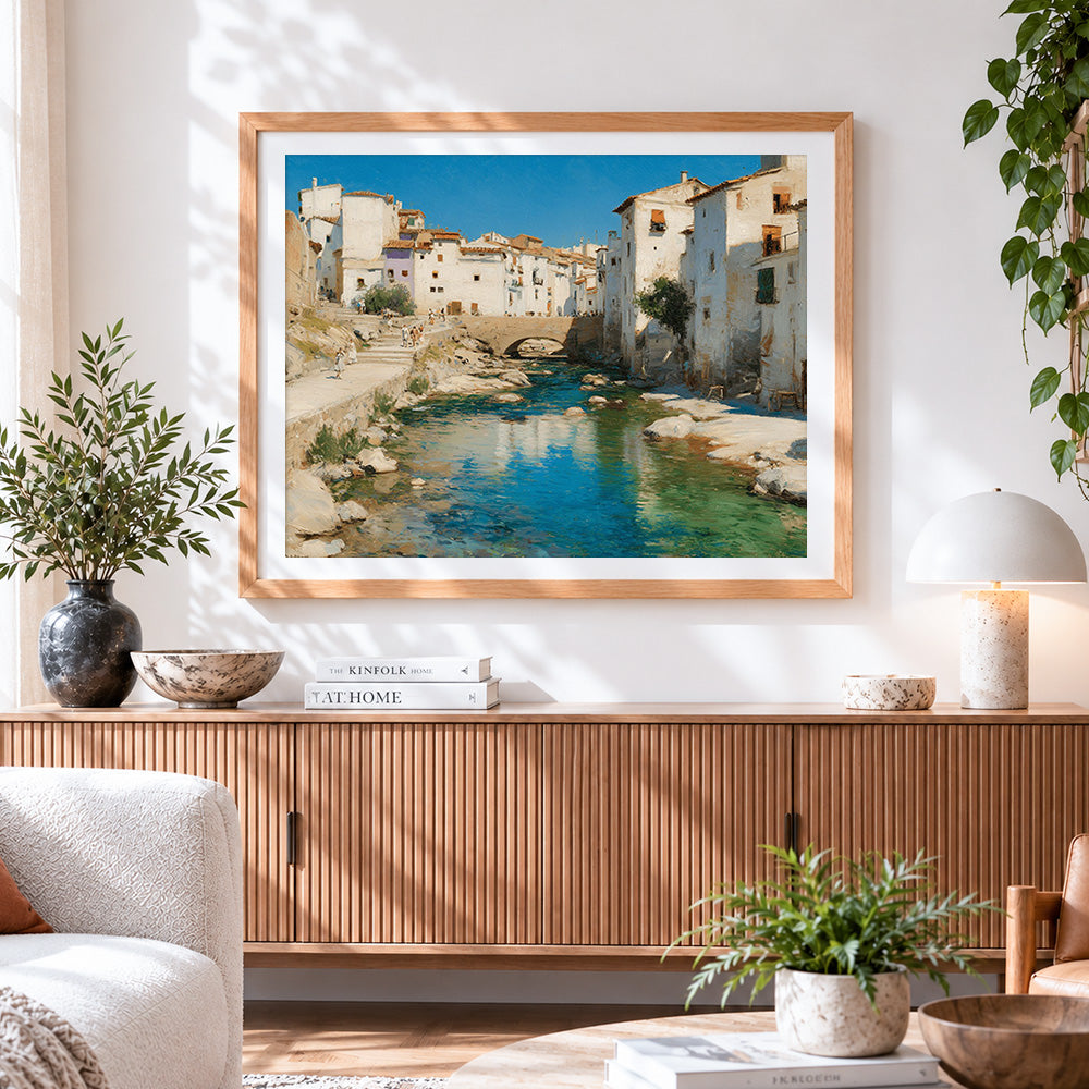 Finished spanish white town and river cross stitch artwork displayed