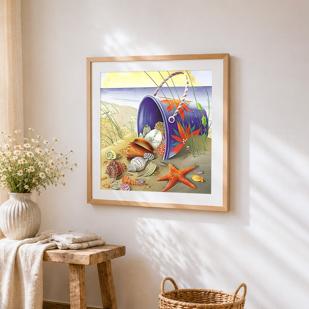 Spilled bucket of seashells on the sand cross stitch artwork displayed on wall as home decor