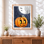 Finished spooky halloween pumpkin and full moon cross stitch artwork displayed
