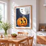 Spooky halloween pumpkin and full moon cross stitch artwork displayed on wall as home decor