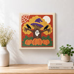Finished spooky halloween tree artwork displayed on a wall