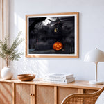 Spooky haunted house and glowing pumpkin cross stitch artwork displayed on wall as home decor