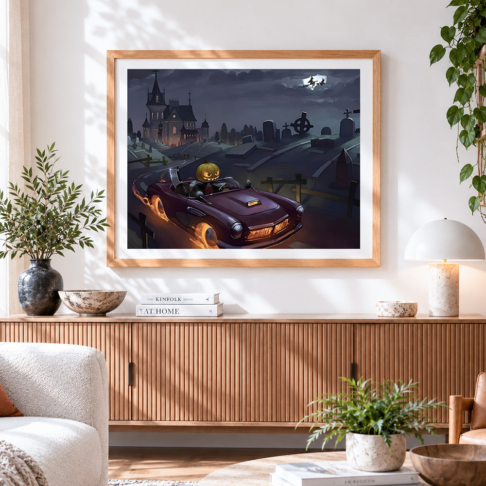 Finished spooky pumpkin head driving a vintage car cross stitch artwork displayed