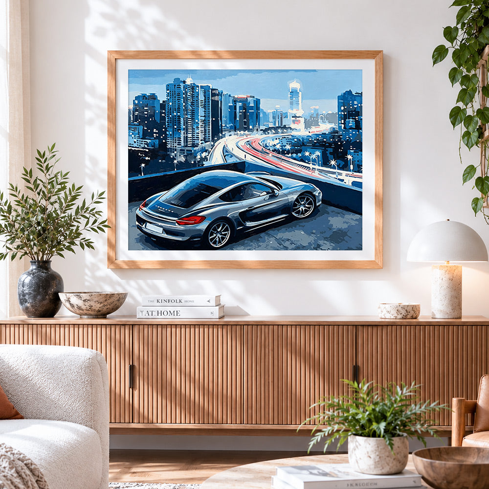 Finished sports car with city skyline cross stitch artwork displayed