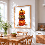 Stacked halloween pumpkins with witch hat cross stitch artwork displayed on wall as home decor