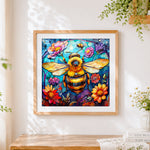 Finished stained glass style bee and flowers cross stitch artwork displayed