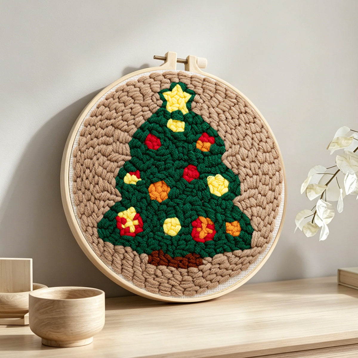 Star topped christmas tree punch needle artwork displayed on a table