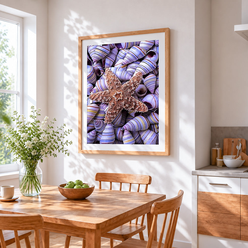 Starfish on purple striped shells cross stitch artwork displayed on wall as home decor