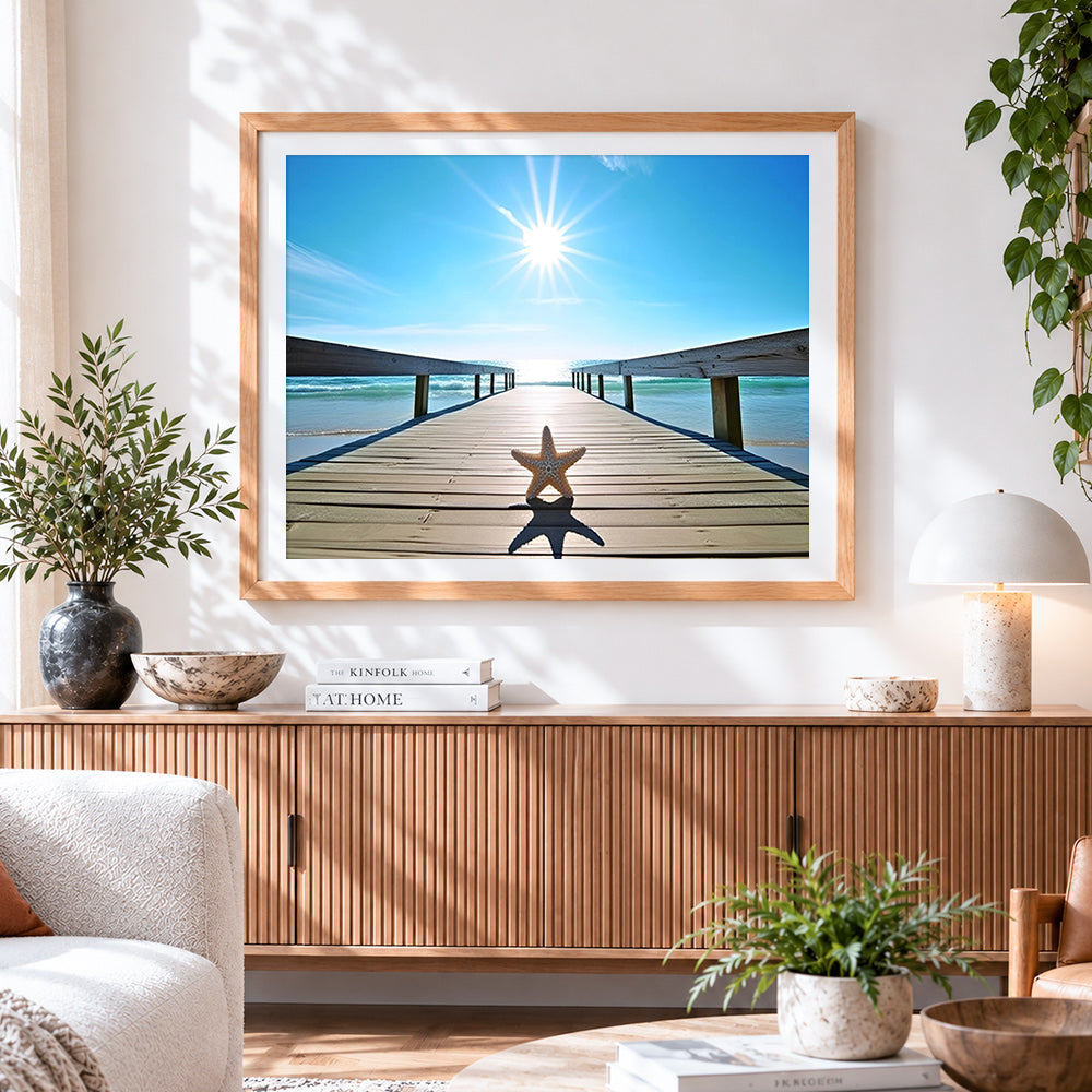 Finished starfish on sunlit pier cross stitch artwork displayed
