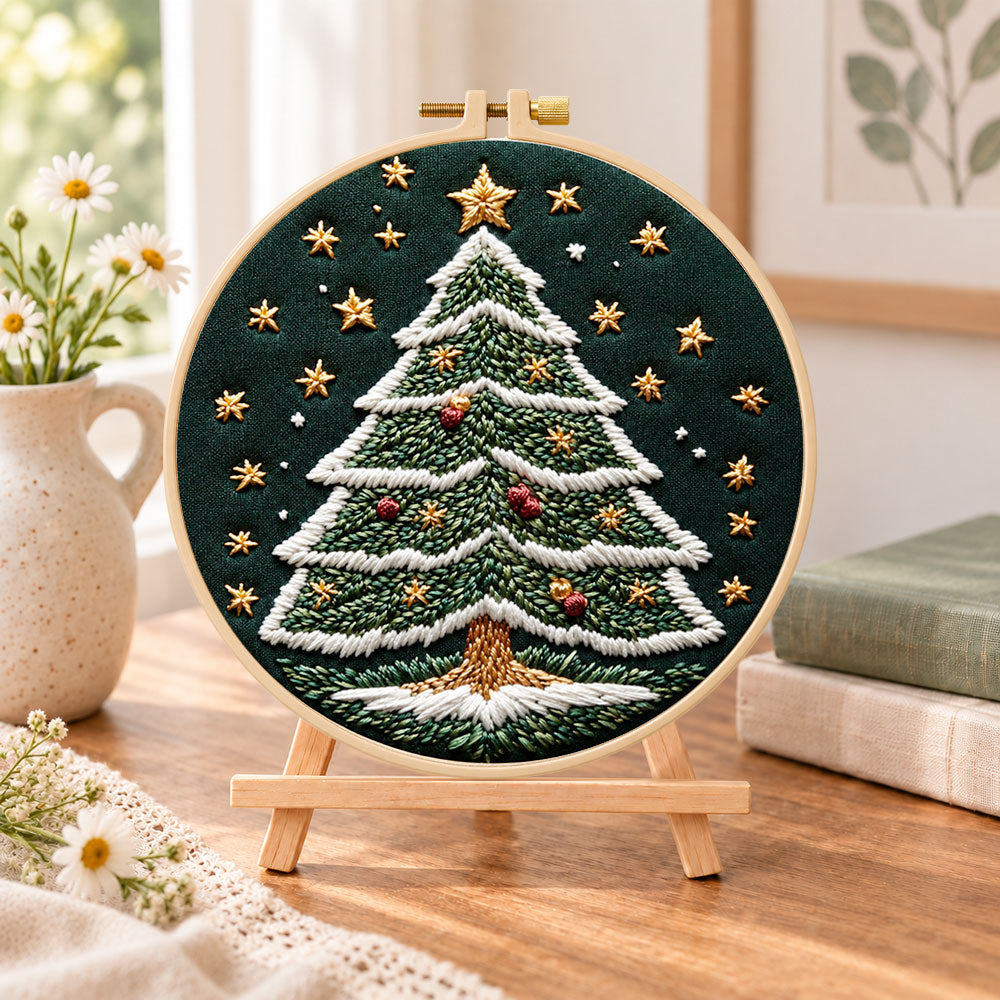 Starry christmas tree embroidery kit finished hoop displayed on a wooden stand as cosy tabletop decor