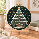 Starry christmas tree embroidery kit finished hoop displayed on a wooden stand as cosy tabletop decor