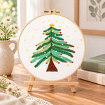Starry christmas tree with stars embroidery kit finished hoop displayed on a wooden stand as cosy tabletop decor