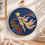 Starry koi fish embroidery hoop wall art displayed as warm and cosy handmade home decor