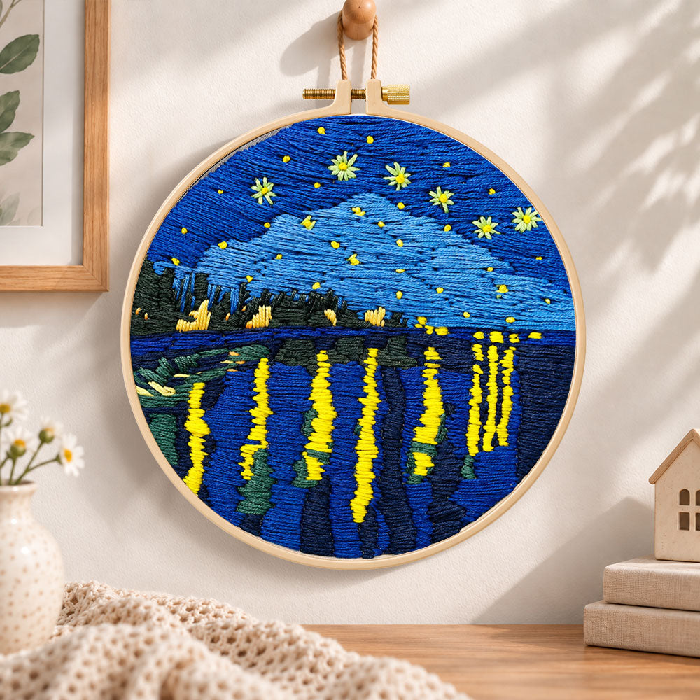Starry night lakeside view embroidery hoop wall art displayed as warm and cozy handmade home decor