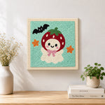 Finished strawberry ghost artwork displayed on a wall