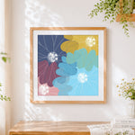 Finished stylised chrysanthemum design cross stitch artwork displayed