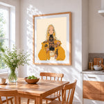 Stylish blonde woman in yellow coat cross stitch artwork displayed on wall as home decor