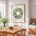 Succulent wreath with birdhouse cross stitch artwork displayed on wall as home decor
