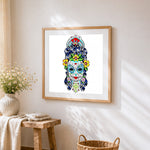 Sugar skull with blue hair cross stitch artwork displayed on wall as home decor